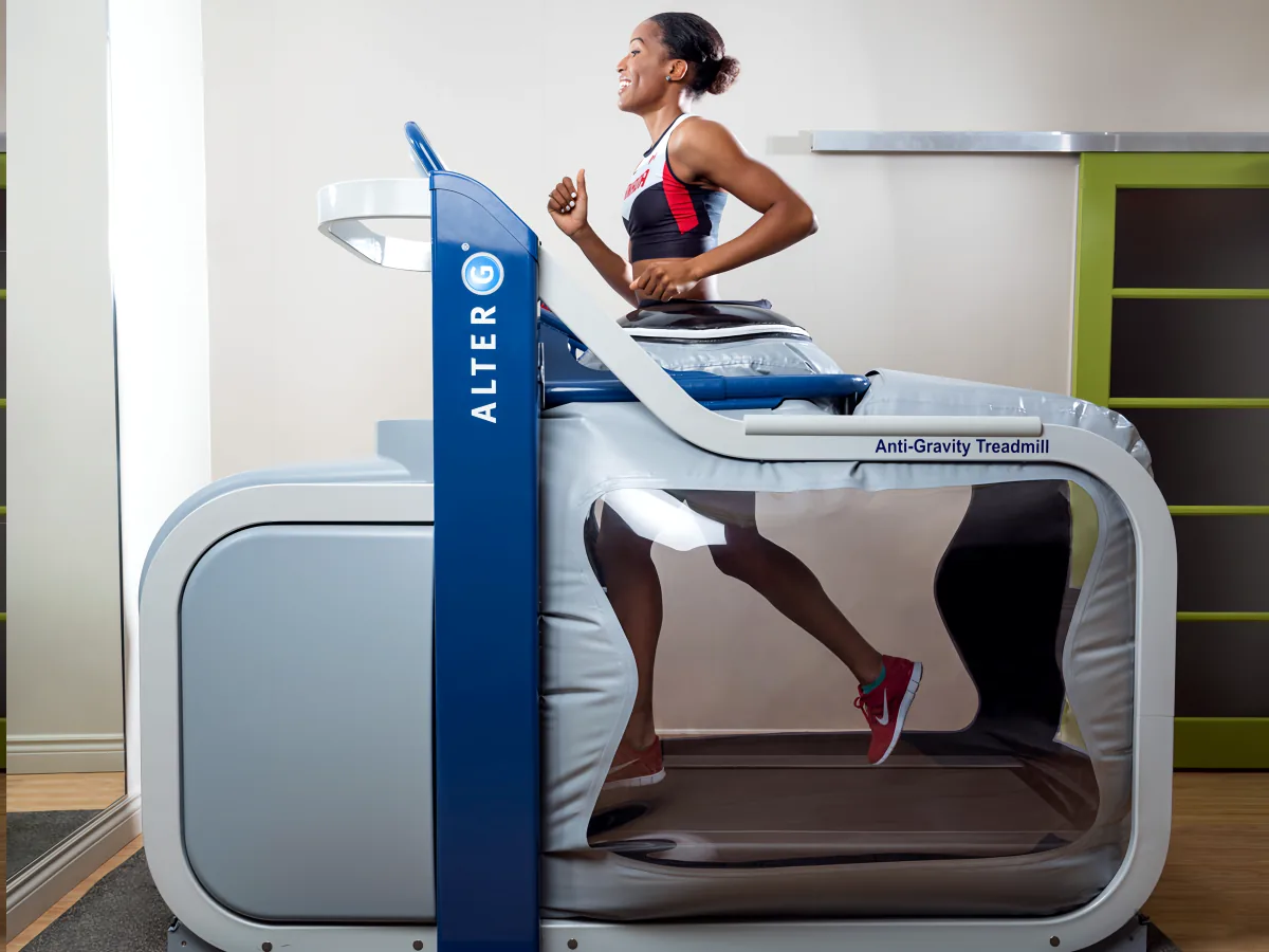 A runner training inside the AlterG Anti-Gravity Treadmill's pressurised air chamber